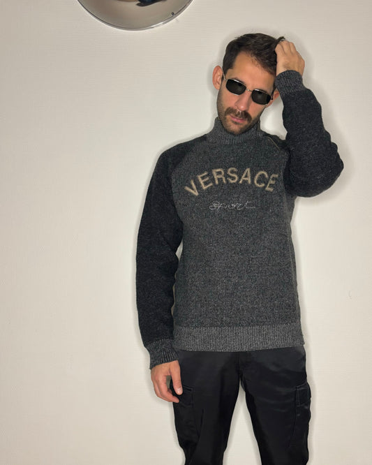 Model wearing the Versace Sport sweatshirt styled with sunglasses.