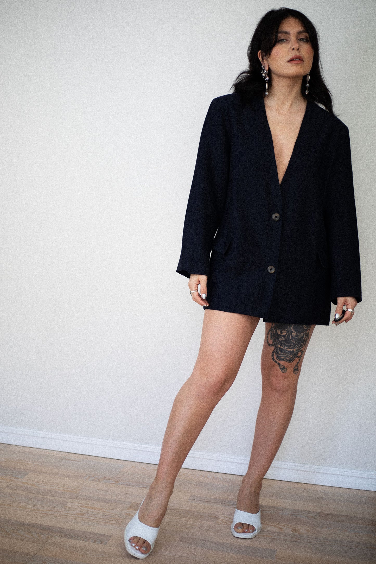 Model wearing navy Missoni blazer styled with heels