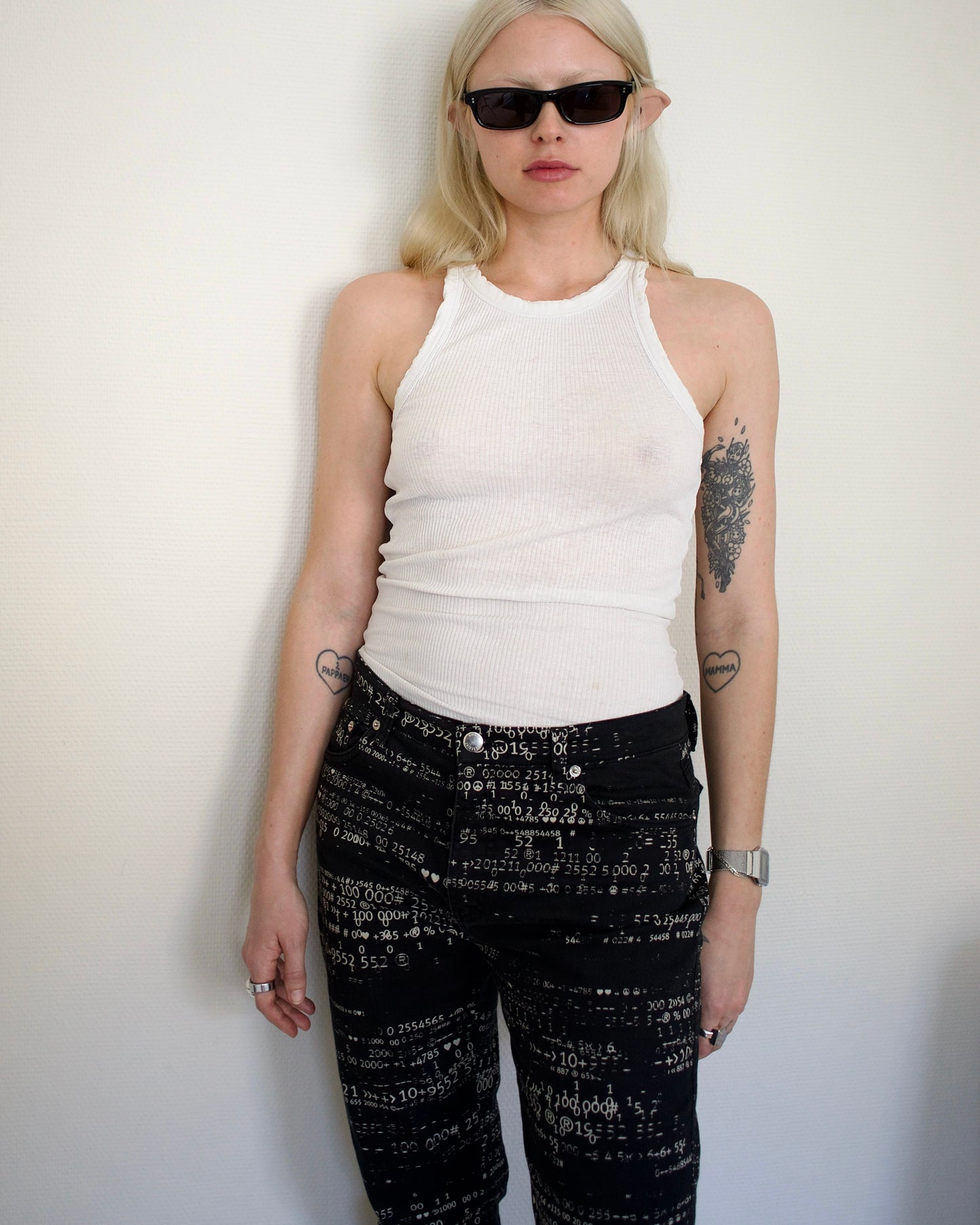 Y2K Moschino pants in black with all-over white number print, worn by a model