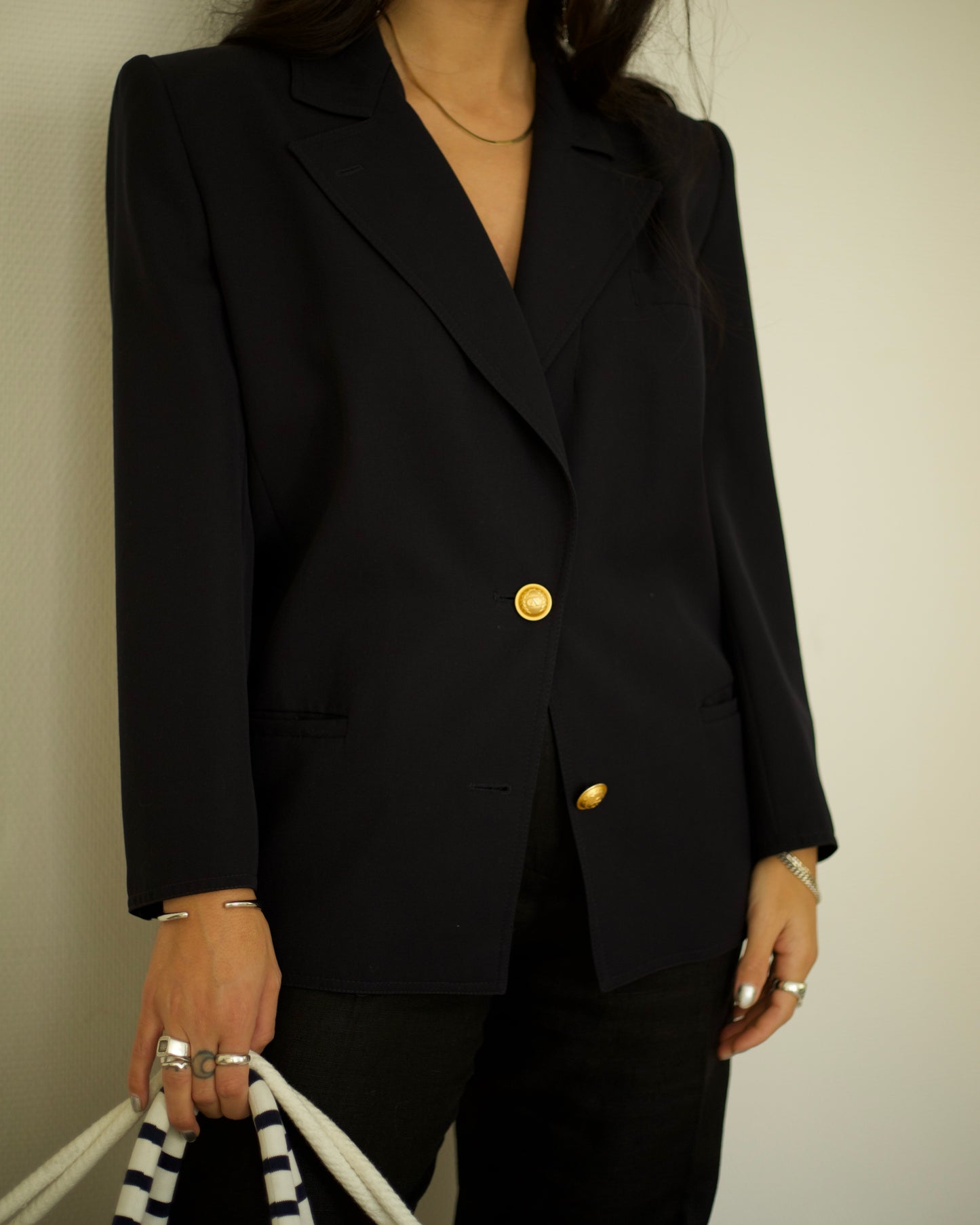 Detail of gold buttons and tailored fit on 1990s Valentino navy blazer
