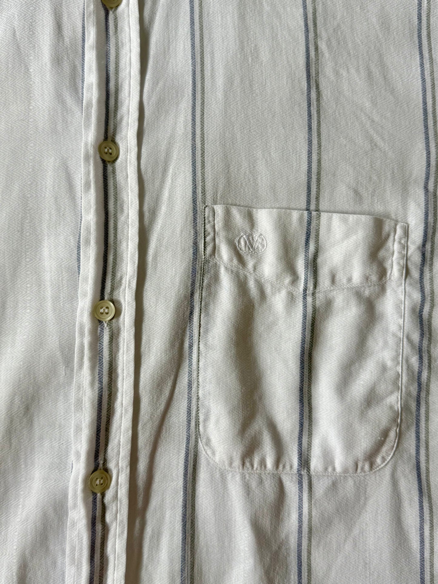 Close-up of chest pocket with embroidered Valentino logo on vintage linen stripe shirt