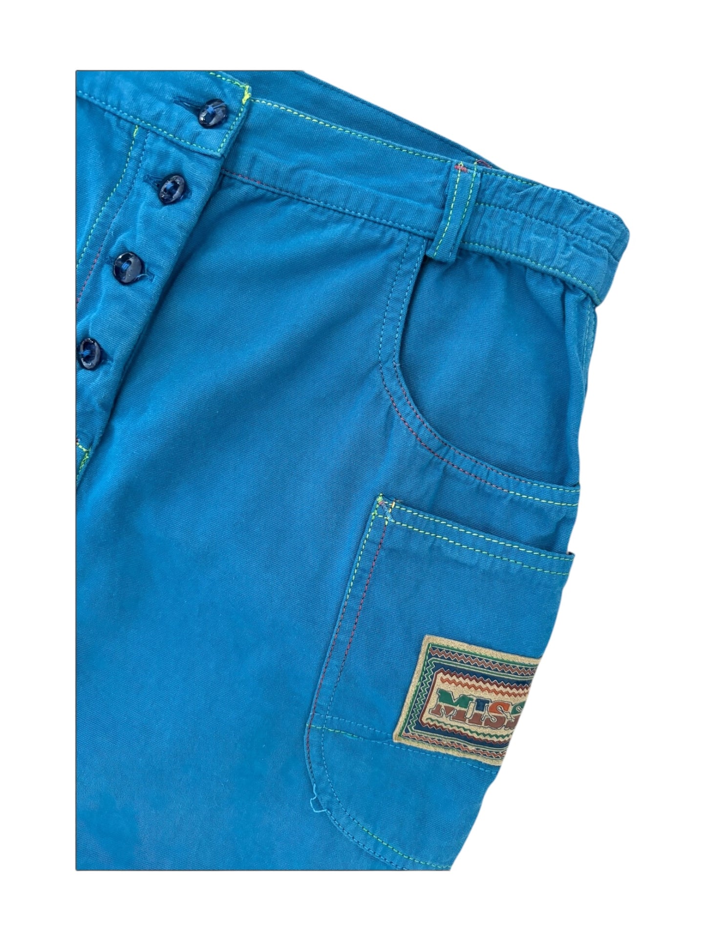 Model wearing 1990s Missoni electric blue cotton mini skirt with utility pockets and logo patch