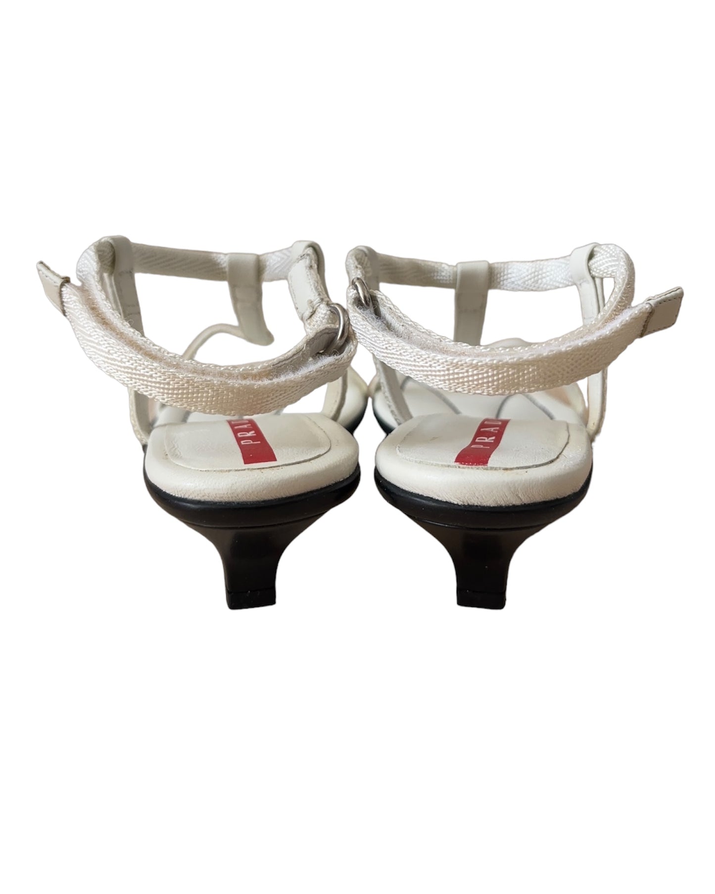 Vintage Prada Linea Rossa white strappy kitten heel sandals with red tab logo, size 37.5, shown against white background.