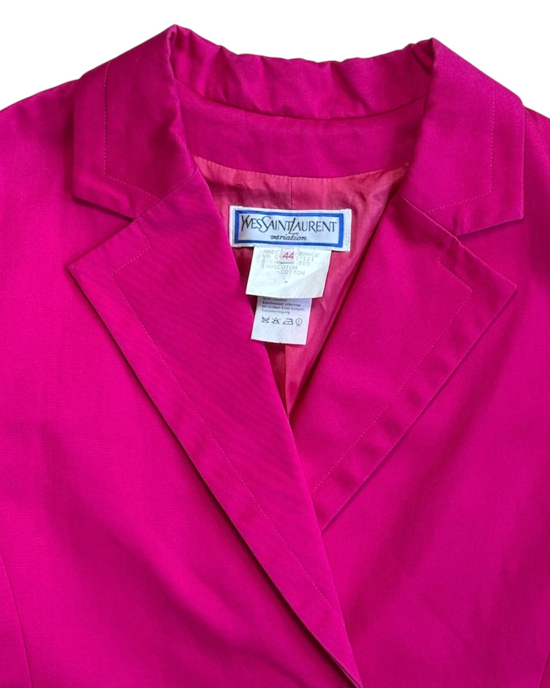 Close-up of a pink jacket with Yves Saint Laurent label.