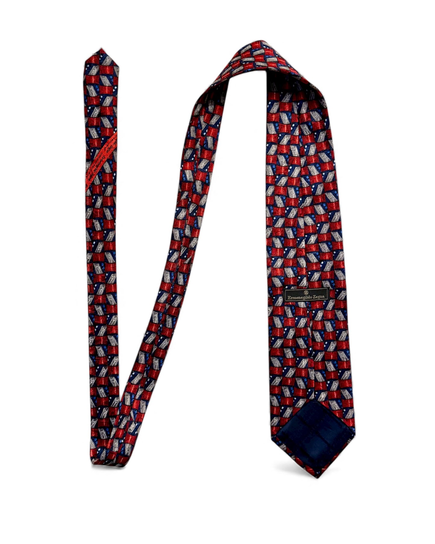 Ermenegildo Zegna vintage silk necktie with red, blue, and silver geometric pattern on a textured silk fabric.