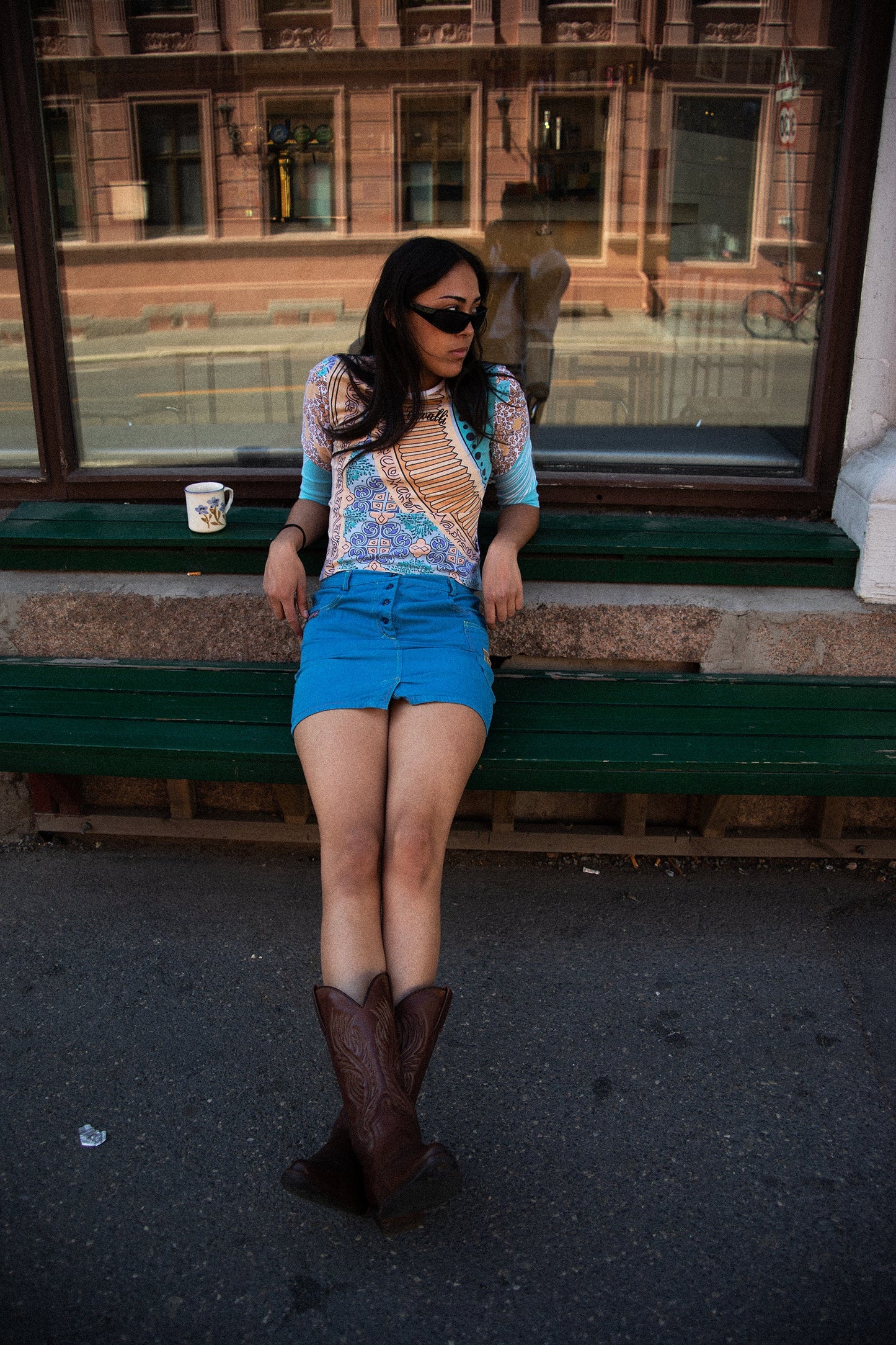 Model wearing 1990s Missoni electric blue cotton mini skirt with utility pockets and logo patch