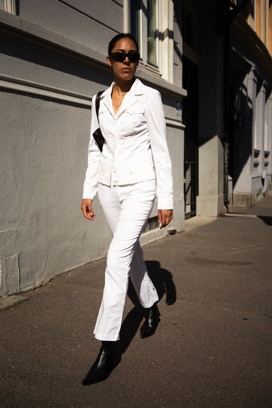Model wearing early 2000s Versace white trousers with slim fit and mid rise