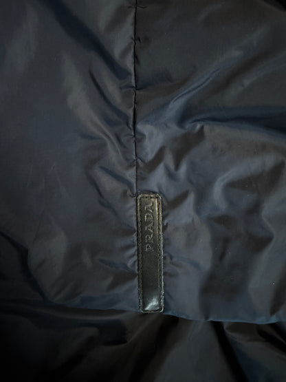 Close-up of a dark blue fabric with a brand label on a matching background
