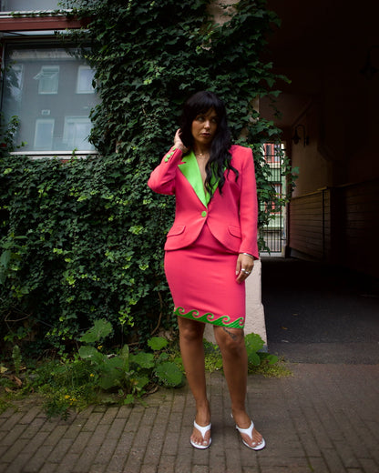 Model wearing the vintage Roccobarocco pink and green skirt suit outdoors