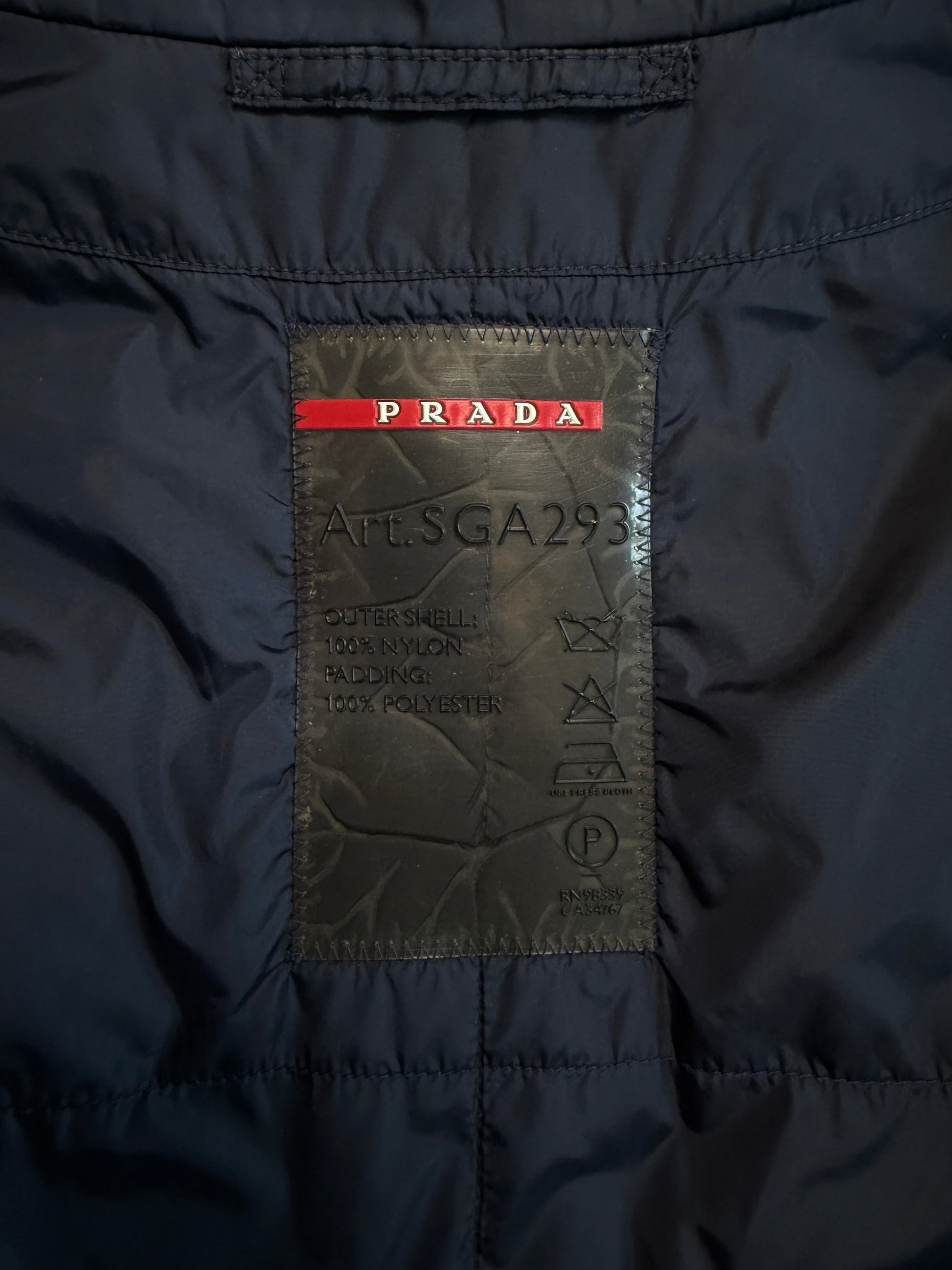Close-up of a Prada label on a dark jacket