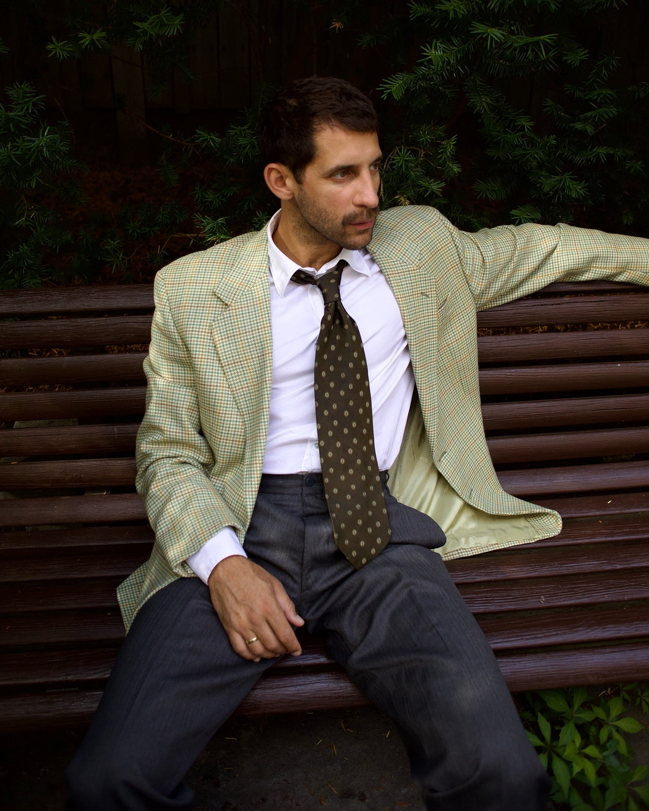 Man in a suit sitting on a bench 
