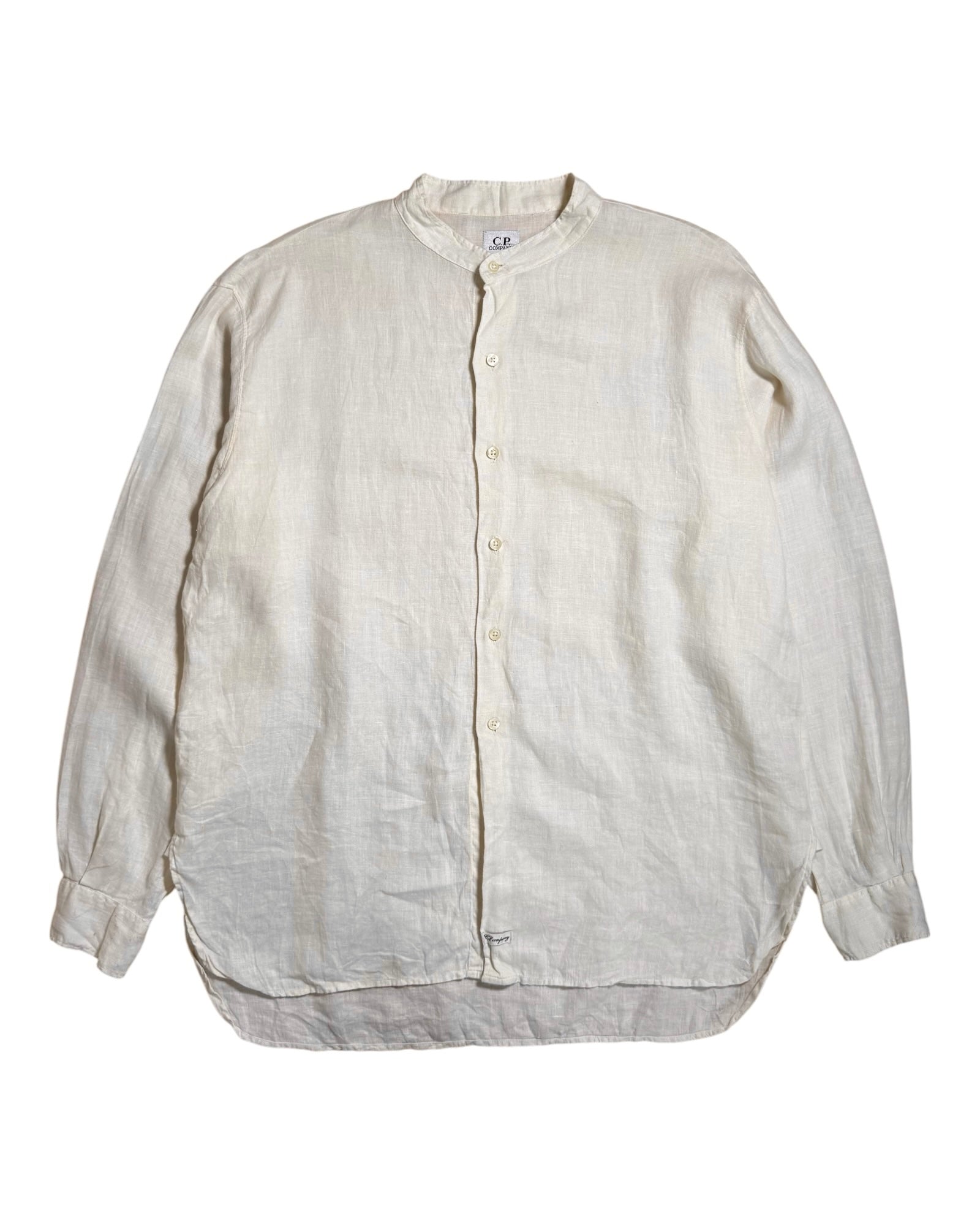 A light beige CP Company linen long-sleeve button-up shirt with a mandarin collar, laid flat against a white background.