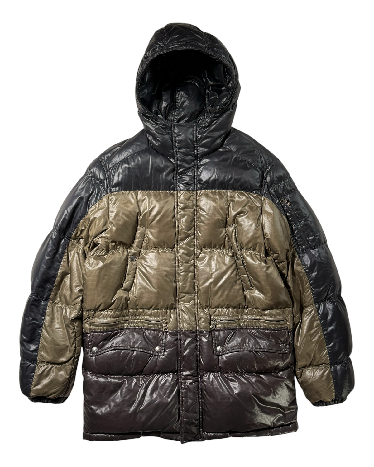 A color-blocked Prada puffer jacket with a shiny black hood and upper body, olive green middle section, and dark brown lower section, shown against a plain white background.