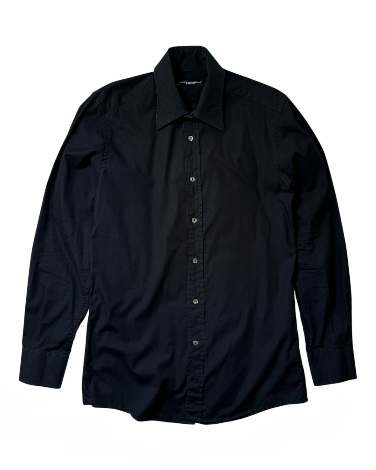 A long-sleeve Dolce & Gabbana button-down shirt in solid black, laid flat against a white background.