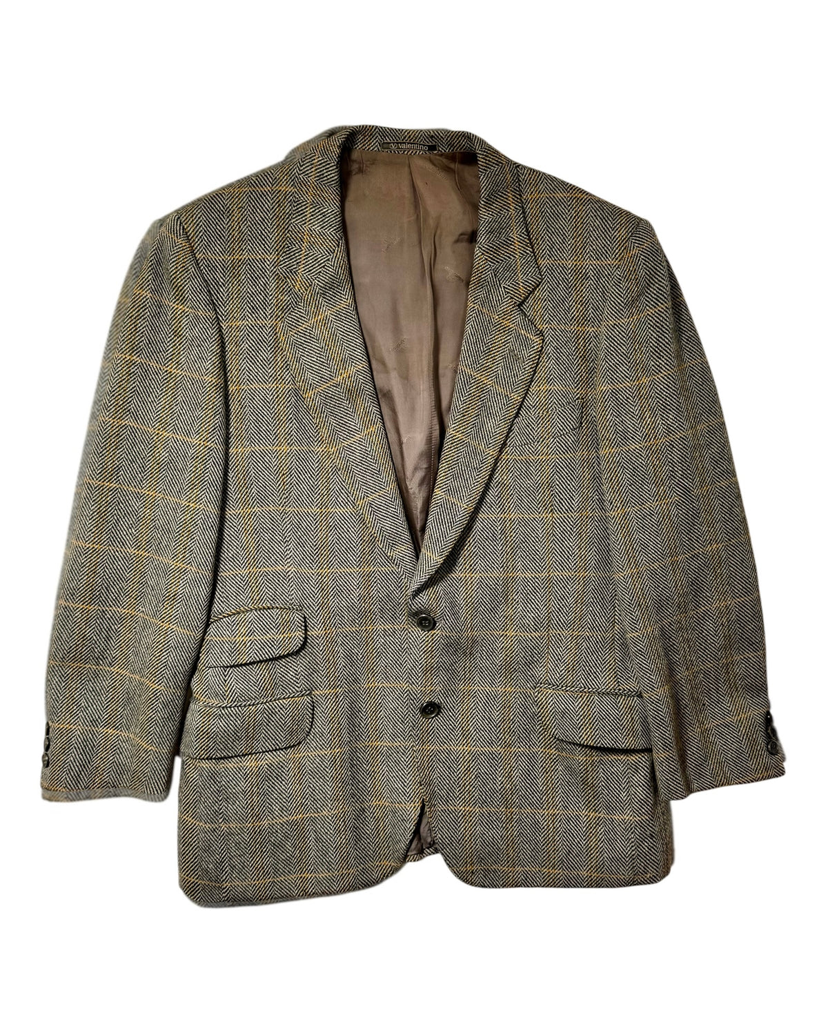 A men's two-button vintage valentino blazer in a brown and beige herringbone tweed with a subtle yellow windowpane check pattern, shown against a plain white background.