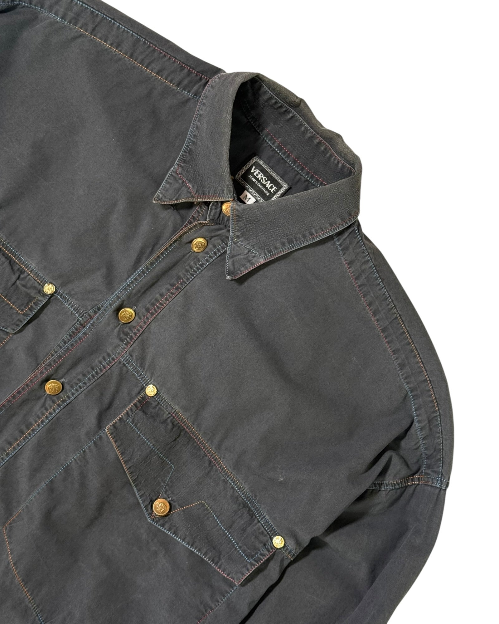 Dark gray versace shirt with button details on a white background