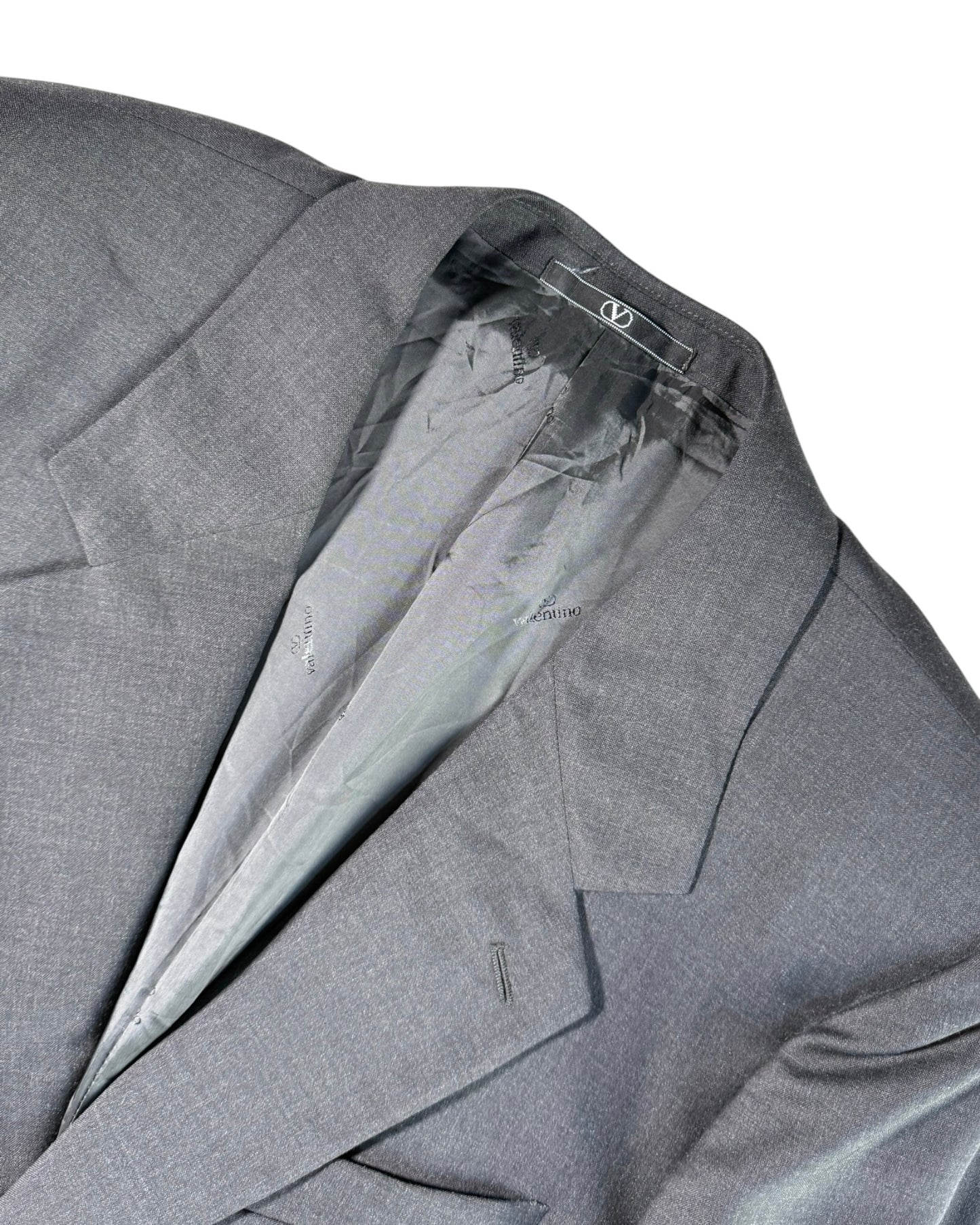 Valentino suit jacket with a close-up of the collar and label on a white background