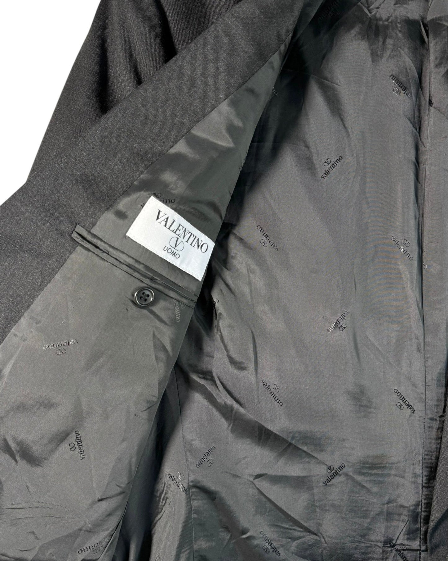 Gray jacket with a Valentino label on a white background