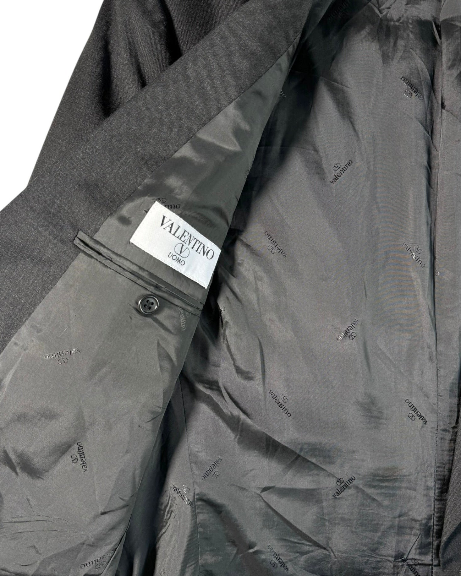 Gray jacket with a Valentino label on a white background