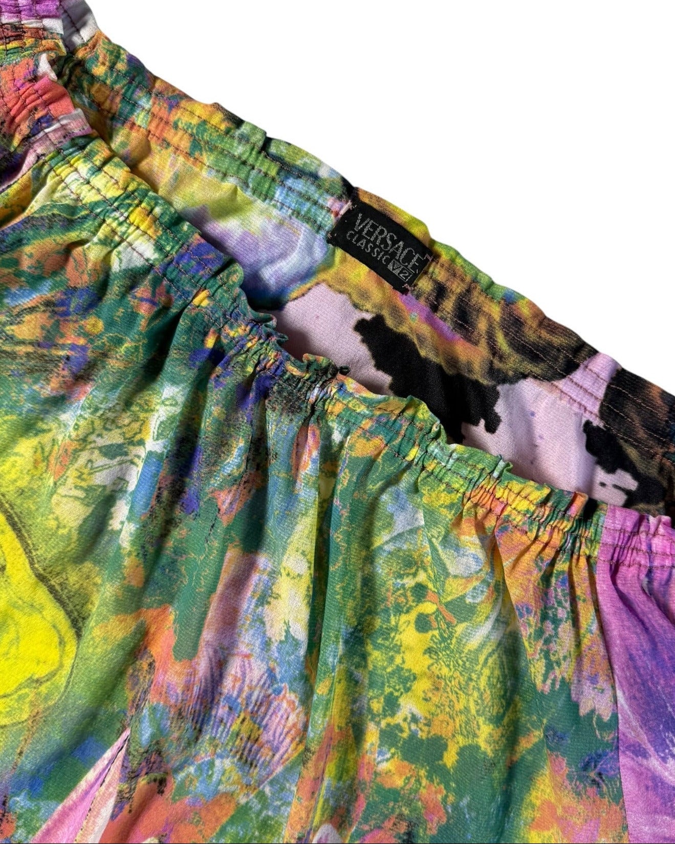 Colorful Versace floral blouse with a white background