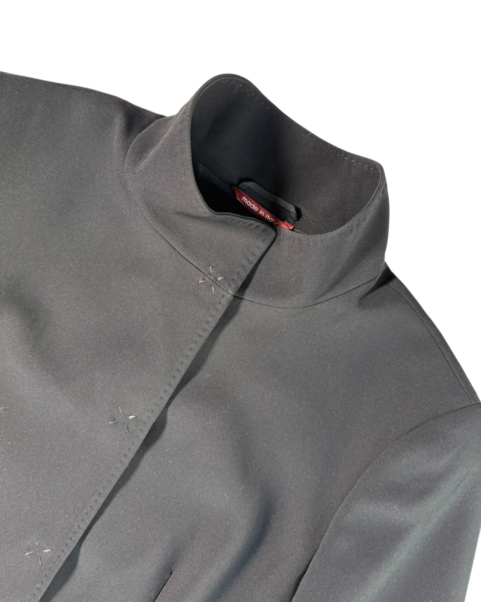 Close-up of Max Mara jacket collar with a brand logo on a white background