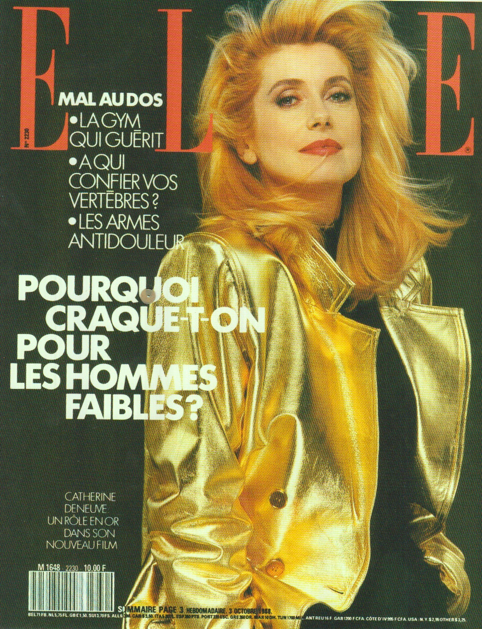 Cover of Elle magazine featuring Catherine Deneuve in a gold Yves Saint Laurent jacket with text in French.