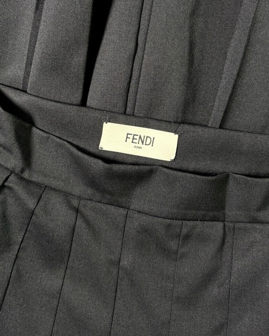 Close-up of a black pleated skirt with Fendi label
