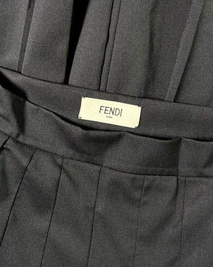 Close-up of a black pleated skirt with Fendi label
