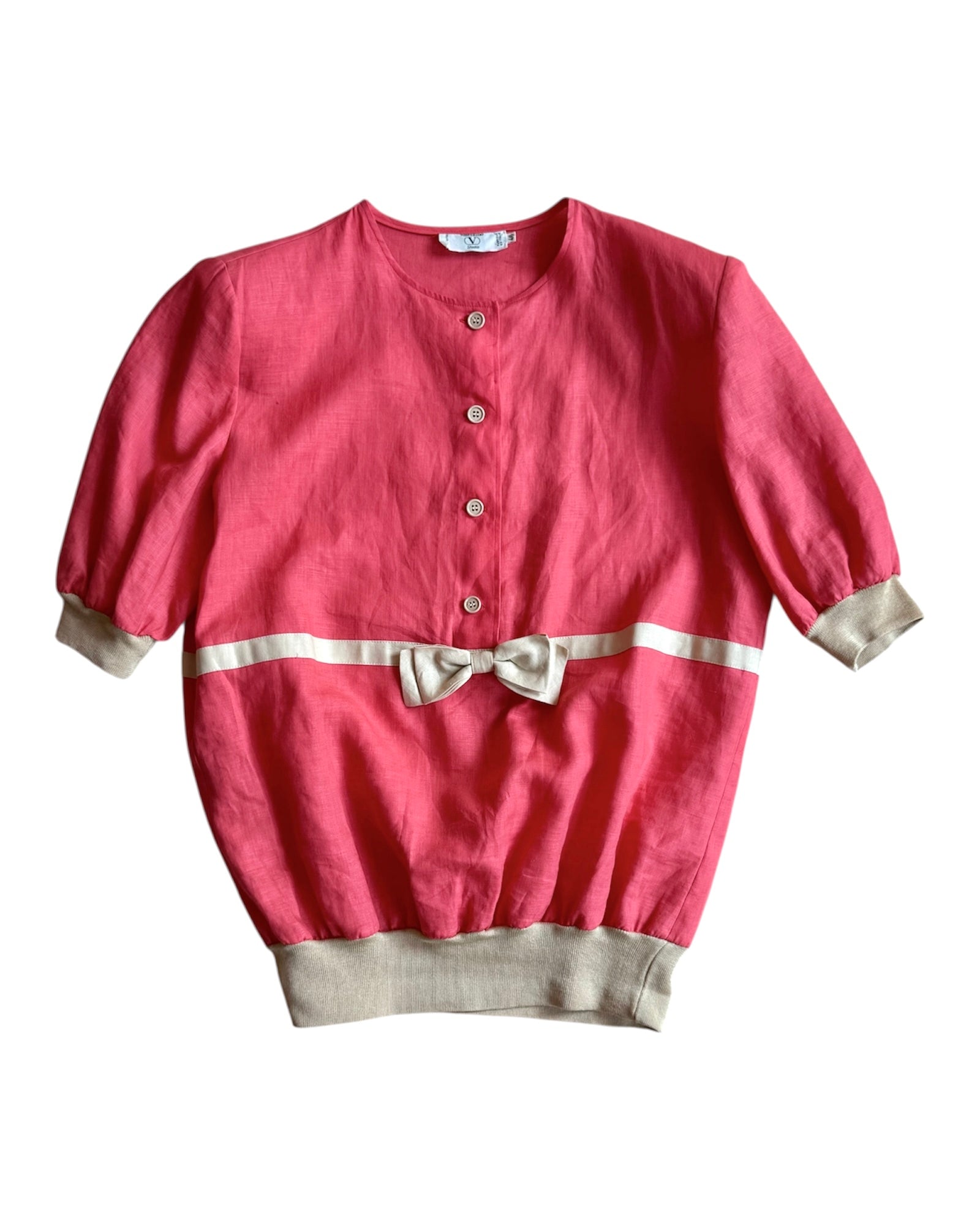 Front view of pink 1980s Valentino linen blouse with padded shoulders and beige knit trim, size L