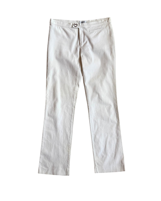 Flat lay of vintage white Moschino pants with heart-shaped button closure, straight leg fit, and mid-rise waist, displayed on a white background.