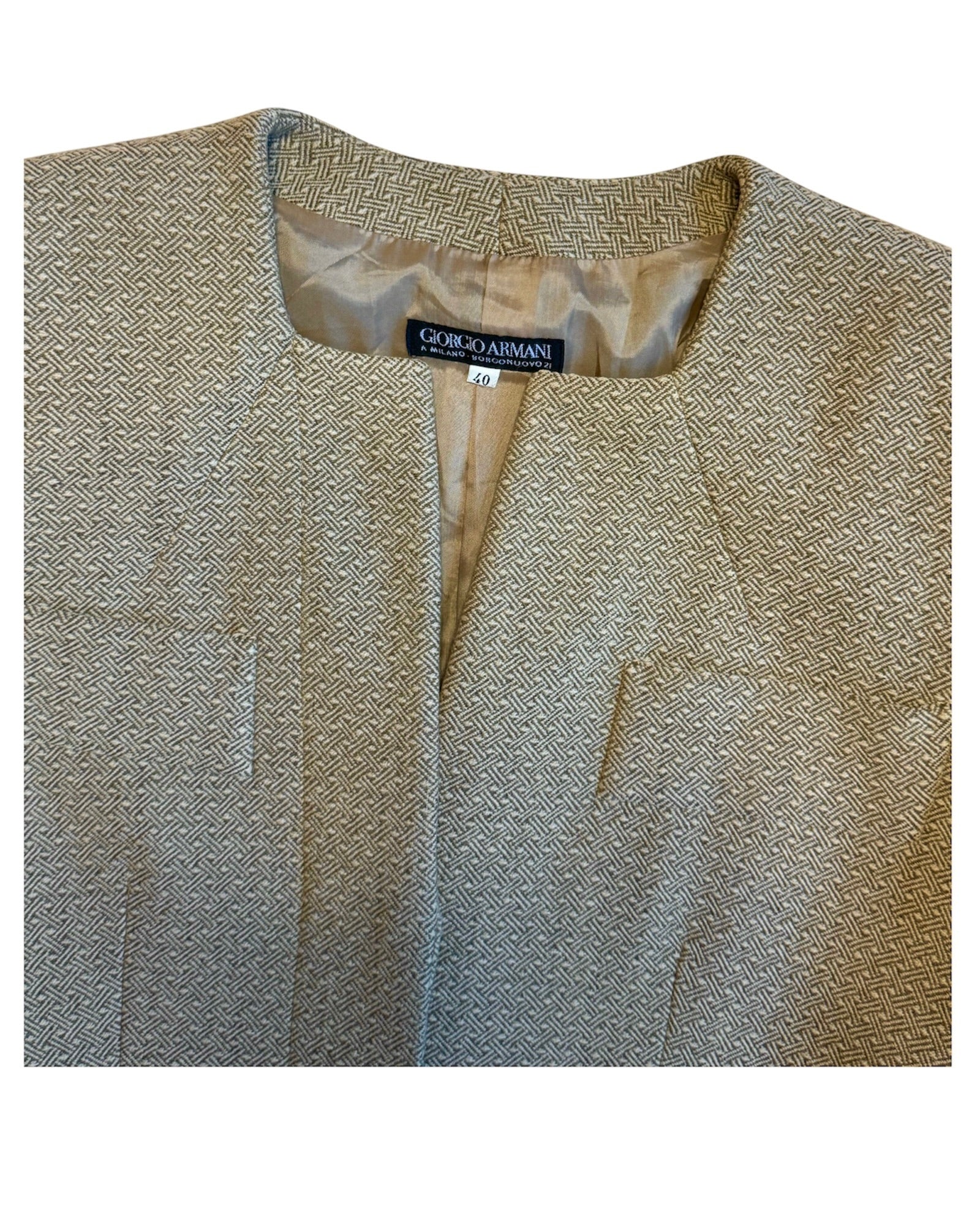 Textured beige jacket with a brand label on a white background