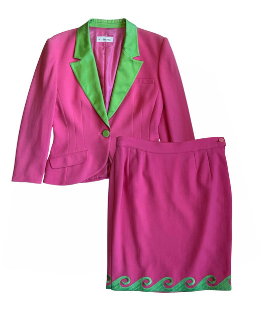 Full view of the Roccobarocco pink and green skirt suit set laid flat