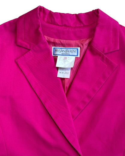 Close-up of a pink jacket with Yves Saint Laurent label.