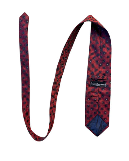 Red patterned tie with a visible brand label on a white background