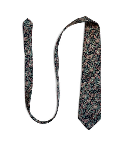 Close-up of Ermenegildo Zegna vintage silk necktie with navy, blush, and green floral geometric pattern.