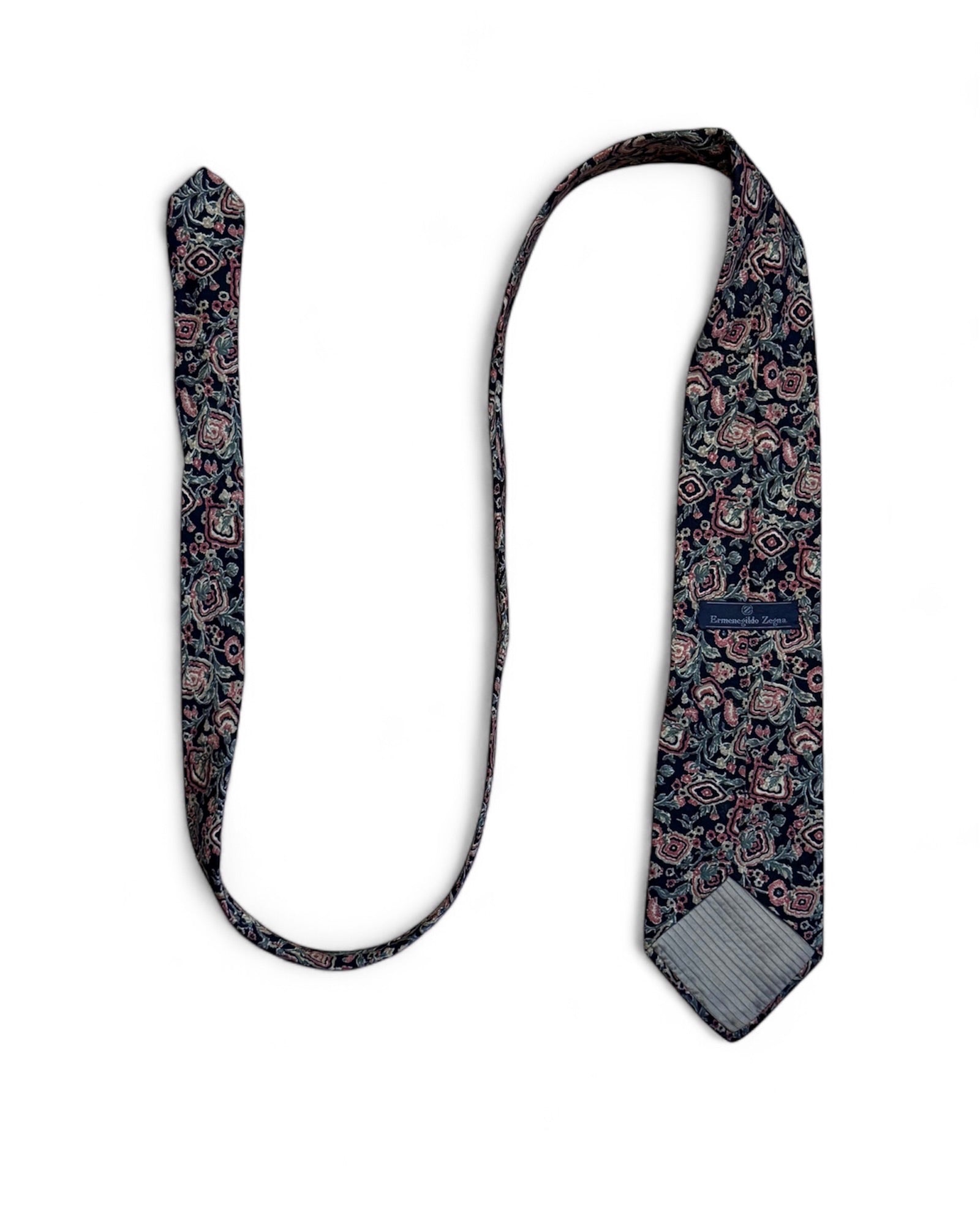 Close-up of Ermenegildo Zegna vintage silk necktie with navy, blush, and green floral geometric pattern.