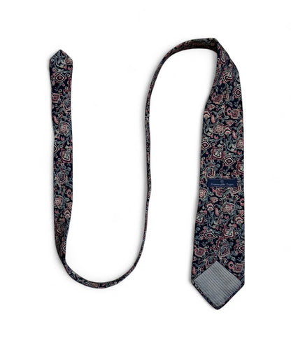 Close-up of Ermenegildo Zegna vintage silk necktie with navy, blush, and green floral geometric pattern.